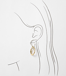 A gold and silver oval earring hangs from a sketched ear against a plain white background. carousel Product Image 2