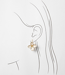A delicate, light pink flower earring hangs from a sketched ear, set against a plain white background. carousel Product Image 2