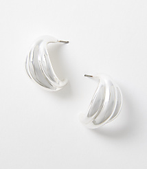 Two silver, ribbed hoop earrings rest on a plain white background. carousel Product Image 1