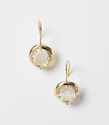 A pair of gold earrings with clear stones hang against a plain white background. carousel Product Image 1