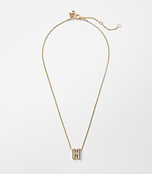 A delicate gold chain necklace with a block letter "H" pendant hangs against a plain white background. carousel Product Image 1