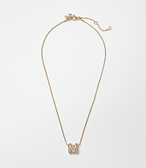 A delicate gold necklace with an "M" pendant rests on a plain white background. carousel Product Image 1