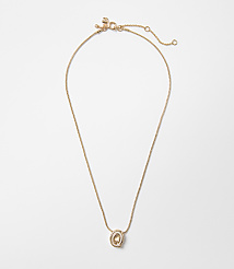 A delicate rose gold necklace with a small, oval pendant hangs against a plain white background. carousel Product Image 1