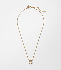 A delicate gold necklace with a sparkling letter "S" pendant hangs against a plain white background. carousel Product Image 1