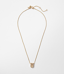 A delicate gold necklace with a stylized "U" pendant rests on a plain white background. carousel Product Image 1