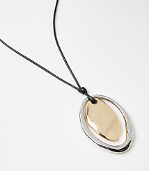 A gold and silver pendant hangs from a black cord against a plain white background. carousel Product Image 2