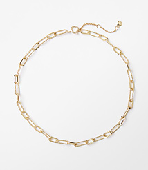 A delicate gold chain necklace with elongated oval links rests on a plain white background. carousel Product Image 1