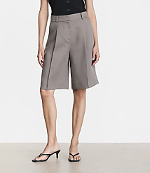 A woman stands in grey culottes and black heeled sandals against a plain white background. carousel Product Image 2