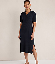 A woman in a navy blue ribbed knit polo dress stands against a plain, light-colored background. carousel Product Image 1