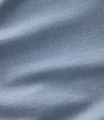 Soft, light blue fabric with gentle folds and shadows fills the frame. carousel Product Image 4