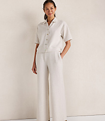 A woman in a linen pajama set stands against a plain, light-colored background. carousel Product Image 1