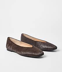 Two brown, furry ballet flats rest on a plain white background. carousel Product Image 1
