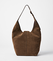A brown suede hobo bag with a single strap hangs against a plain white background. carousel Product Image 1