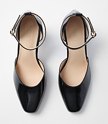 A pair of glossy black patent leather d'Orsay flats with ankle straps rests on a plain white background. carousel Product Image 3
