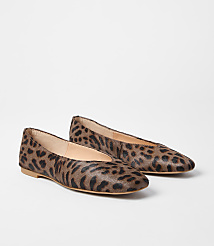 A pair of leopard-print ballet flats rests on a plain white background. carousel Product Image 1