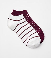 Two ankle socks, one white with maroon stripes and the other maroon with white polka dots, lie on a plain white background. carousel Product Image 1
