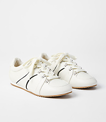 A pair of white leather sneakers with crystal embellishments and black accents are displayed against a plain white background. carousel Product Image 1