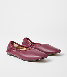 A pair of deep red ballet flats rests on a plain white background. carousel Product Image 1