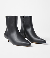 A pair of black leather kitten heel ankle boots with pointed toes are displayed against a plain white background. carousel Product Image 1