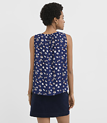 A woman in a floral print top and dark skirt stands against a plain white background. carousel Product Image 3