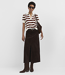 A woman in a striped shirt and brown skirt stands against a plain white background. carousel Product Image 1