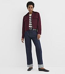 A woman in a maroon jacket and dark jeans stands against a plain white background. carousel Product Image 2
