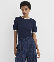 A woman in a navy blue t-shirt and pinstripe pants stands against a plain white background. carousel Product Image 1