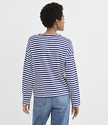 A woman in a striped shirt and jeans stands against a plain white background. carousel Product Image 3