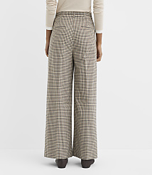 A person wearing wide-leg houndstooth pants stands against a plain white background. carousel Product Image 3