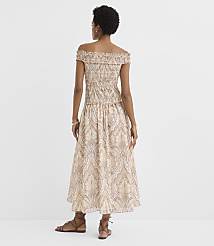 A woman in a patterned off-the-shoulder dress stands against a plain white background. carousel Product Image 3