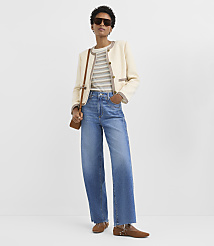 A woman in a cream jacket and striped shirt stands against a plain white background. carousel Product Image 2