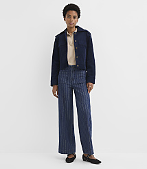 A woman in a navy jacket and pinstripe pants stands against a plain white background. carousel Product Image 1