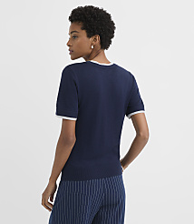 A woman in a navy blue sweater and pinstripe pants stands against a plain white background. carousel Product Image 3