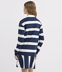 A young woman in a navy and white striped rugby dress stands against a plain white background. carousel Product Image 3