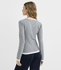 A woman in a grey long-sleeved shirt and navy pants stands against a plain white background. carousel Product Image 3