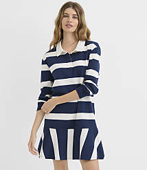 A woman in a navy and white striped polo dress stands against a plain white background. carousel Product Image 1