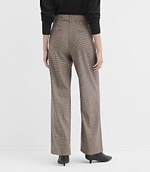 A person wearing brown plaid wide-leg pants and black heeled boots stands against a plain white background. carousel Product Image 3