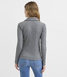 A woman in a grey ribbed sweater and blue jeans stands against a plain white background. carousel Product Image 3