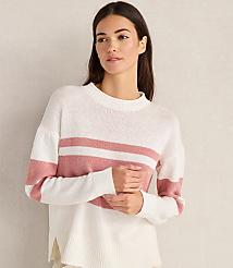 A woman in a white and pink striped sweater stands against a plain, light-colored background. carousel Product Image 3