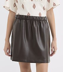A person wears a brown faux leather mini skirt with a patterned blouse, set against a plain white background. carousel Product Image 2