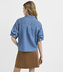 A woman in a denim shirt and brown skirt stands against a plain white background. carousel Product Image 3