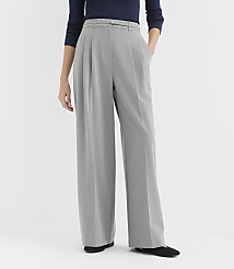 A person stands in light gray pleated wide-leg pants and black flats against a plain white background. carousel Product Image 2