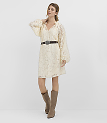 A woman in a cream lace dress and brown boots stands against a plain white background. carousel Product Image 1