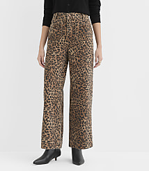 A person stands in the foreground wearing leopard print wide-leg pants and black boots, against a plain white background. carousel Product Image 1
