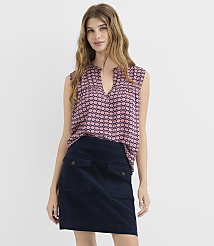 A woman in a patterned top and navy skirt stands against a plain white background. carousel Product Image 2