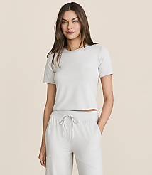 A woman in a light gray cropped t-shirt and matching drawstring pants stands against a plain, light beige background. carousel Product Image 1