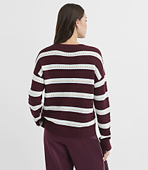 A woman in a maroon and white striped sweater stands against a plain white background. carousel Product Image 3
