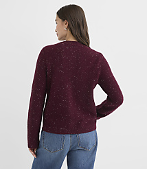 A woman in a maroon speckled sweater and blue jeans stands against a plain white background. carousel Product Image 3