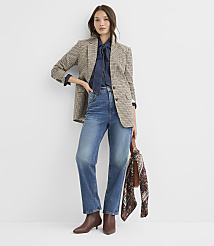 A woman in a patterned blazer, denim shirt, and jeans stands against a plain white background, holding a patterned scarf. carousel Product Image 2