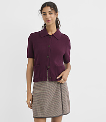 A woman in a burgundy collared cardigan and a plaid skirt stands against a plain white background. carousel Product Image 1